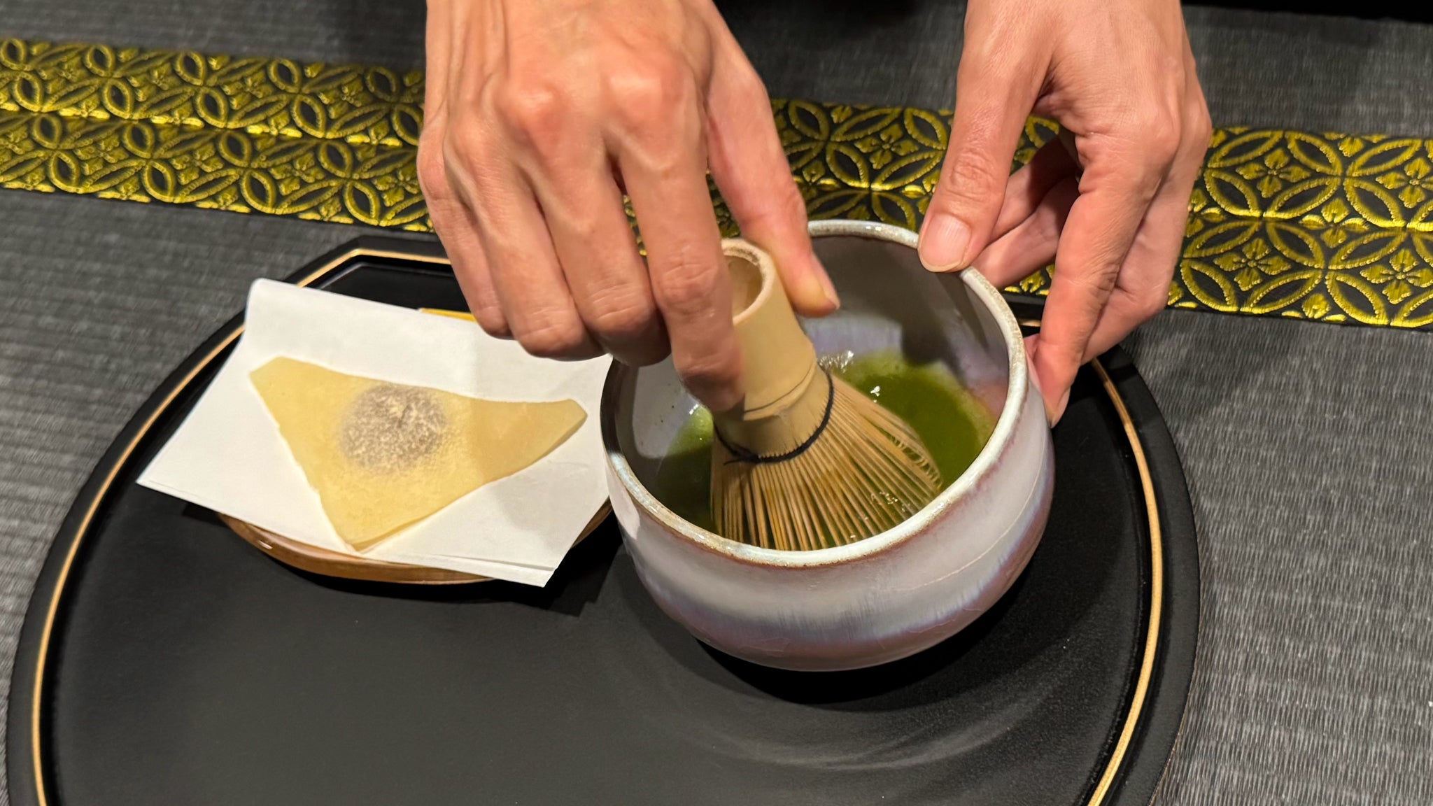 Guests enjoying hands-on matcha whisking inside the Black Matcha Room Studio