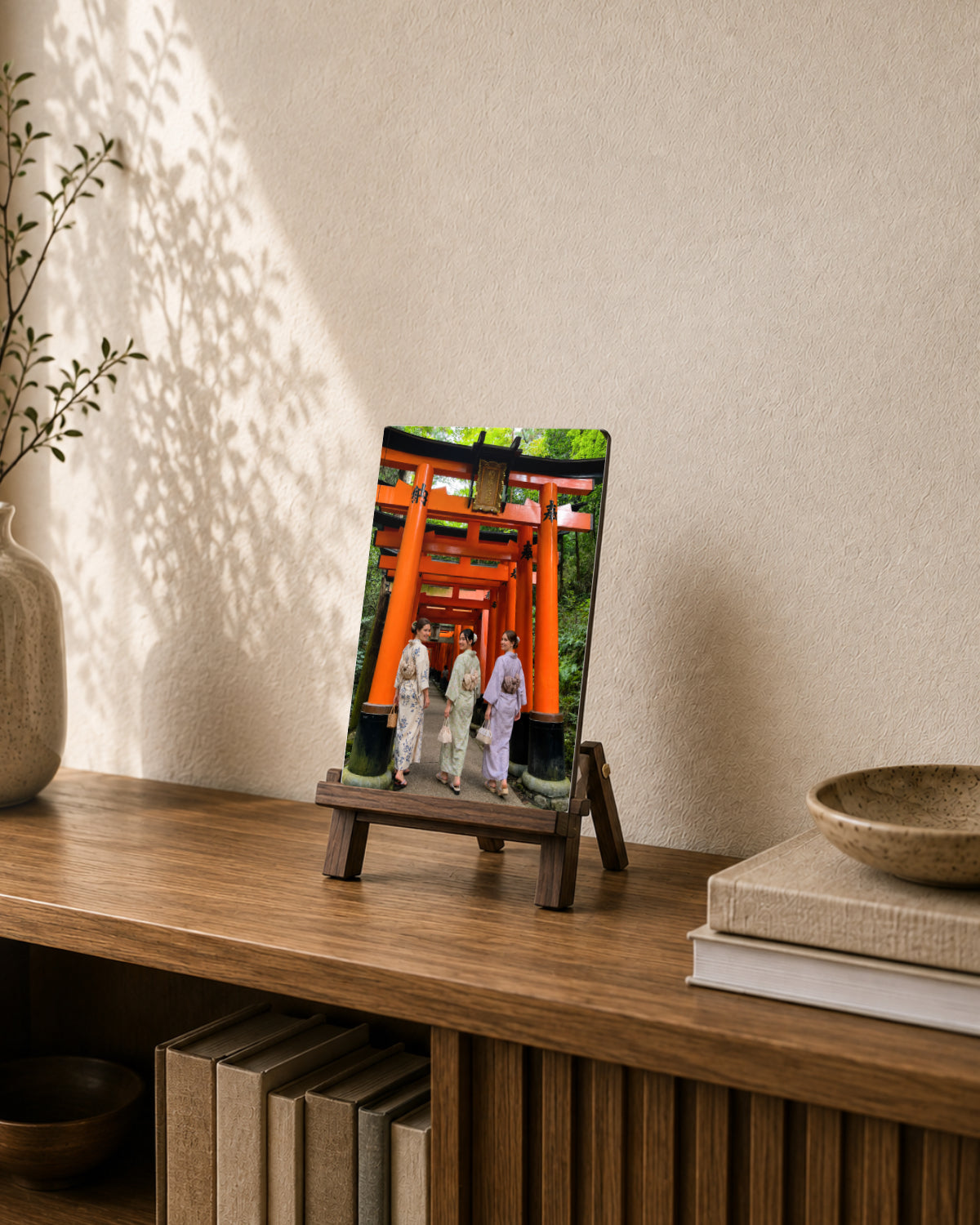 A Japan travel photo displayed as A4 metal art on a wooden tabletop easel